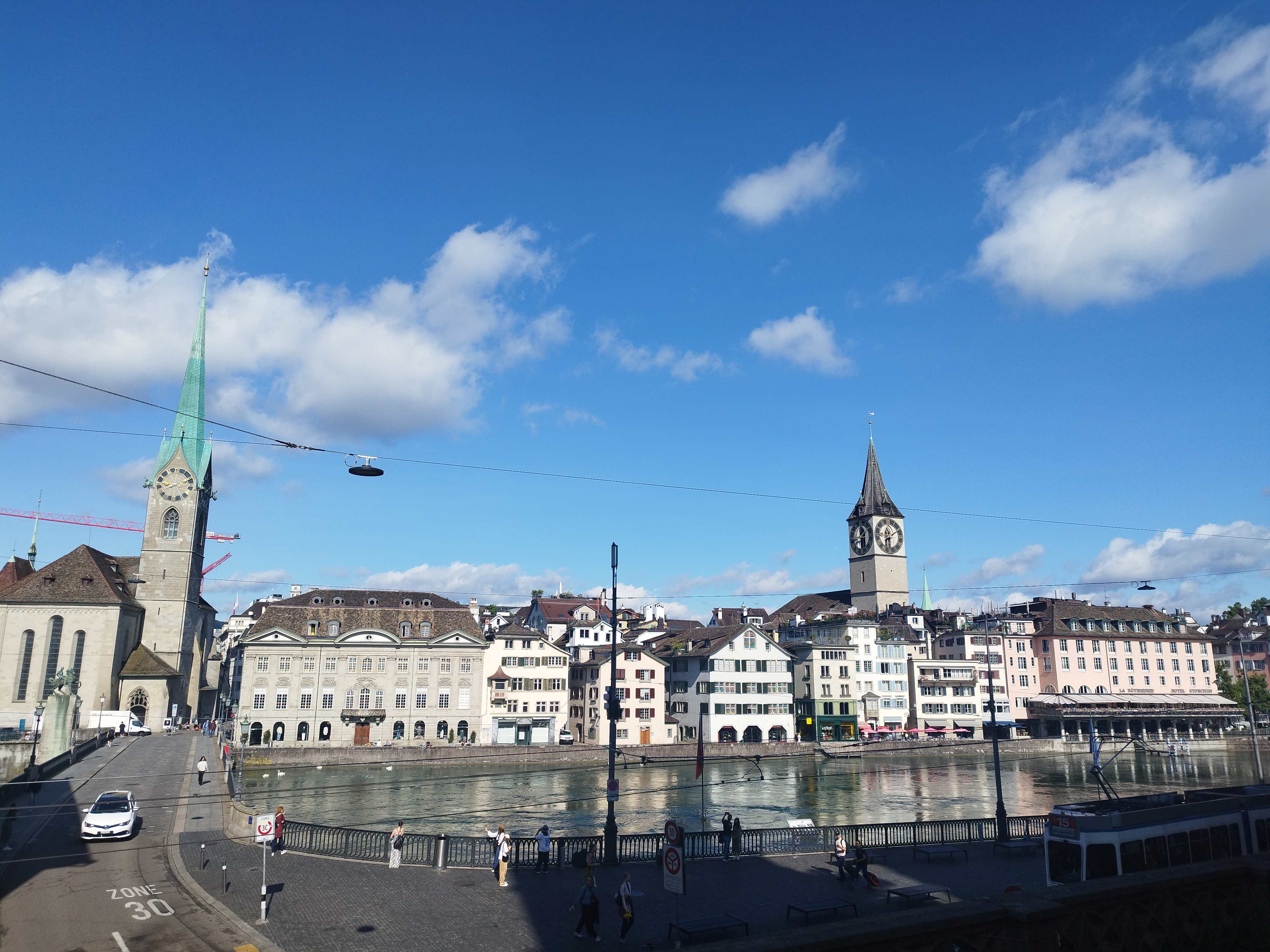 Panoramic view of the Limmat River in Zurich old town with Fraumünster and St. Peter Church