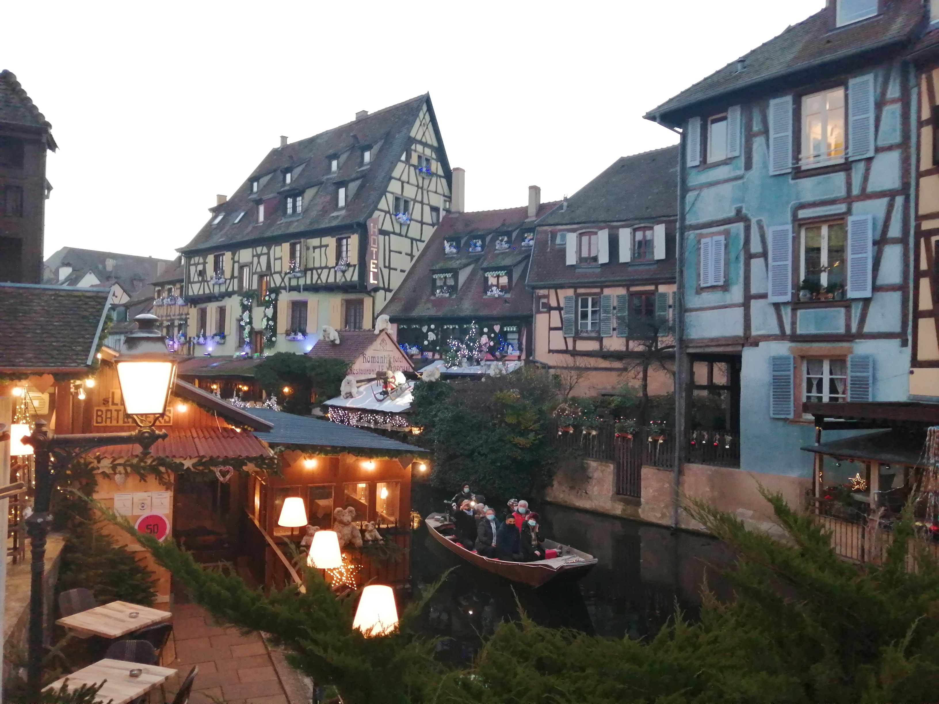 Beautiful vertical view of Colmar historic half-timbered houses along the scenic canals of Little Venice